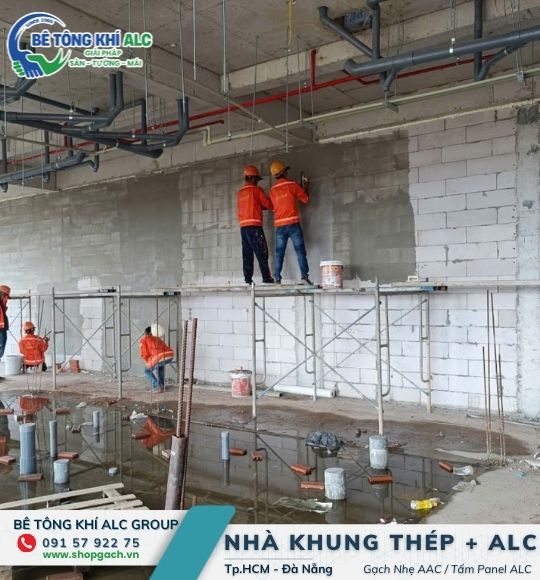 Đội thi công lắp đặt và xử lý vách ngăn cháy panel ALC có lõi thép trên giàn giáo tại công trình